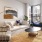 Spacious and well lit living room with wood floors and an open floor plan with access to the kitchen.
